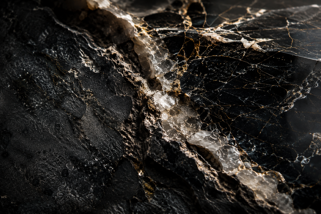 Macro view of natural stone showing veins, fractures and mineral inclusions under dramatic light.