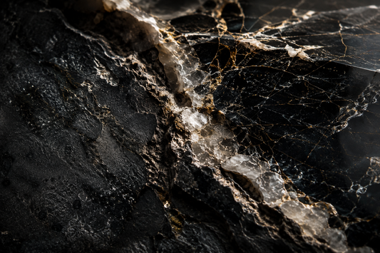 Macro view of natural stone showing veins, fractures and mineral inclusions under dramatic light.