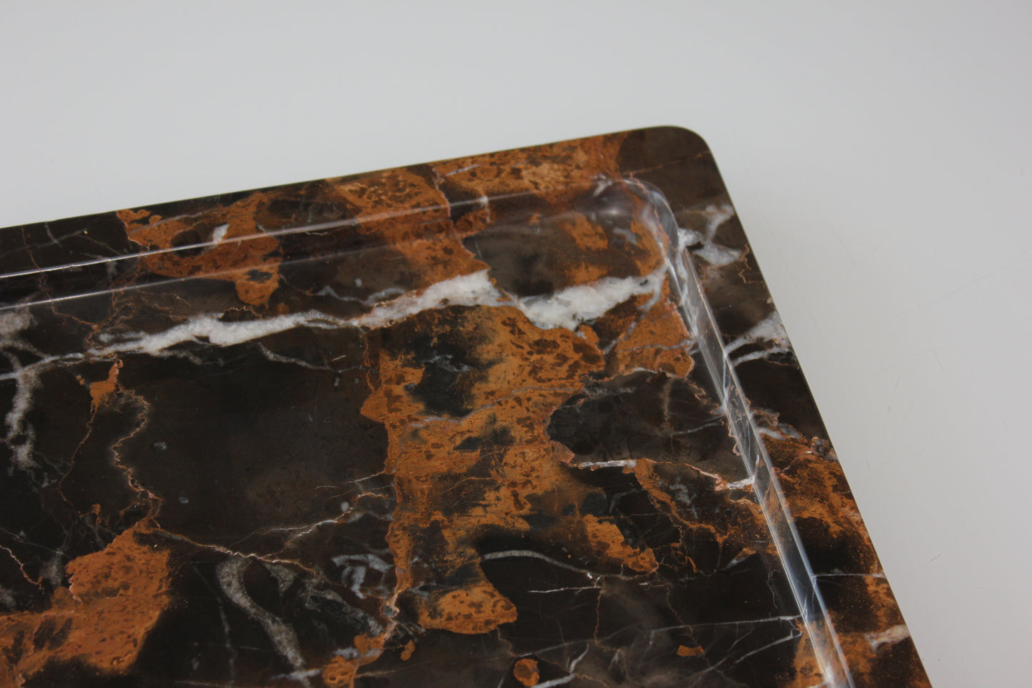 Rounded inner edge carved from a single block of Portoro marble.