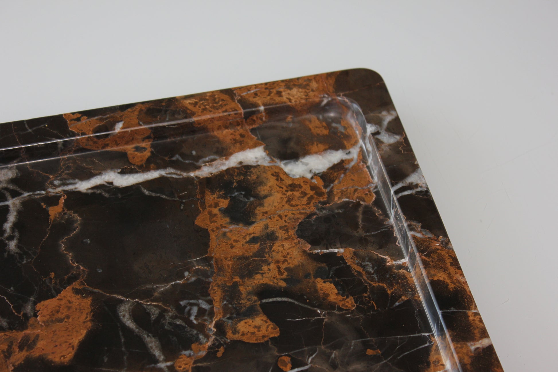 Rounded inner edge carved from a single block of Portoro marble.