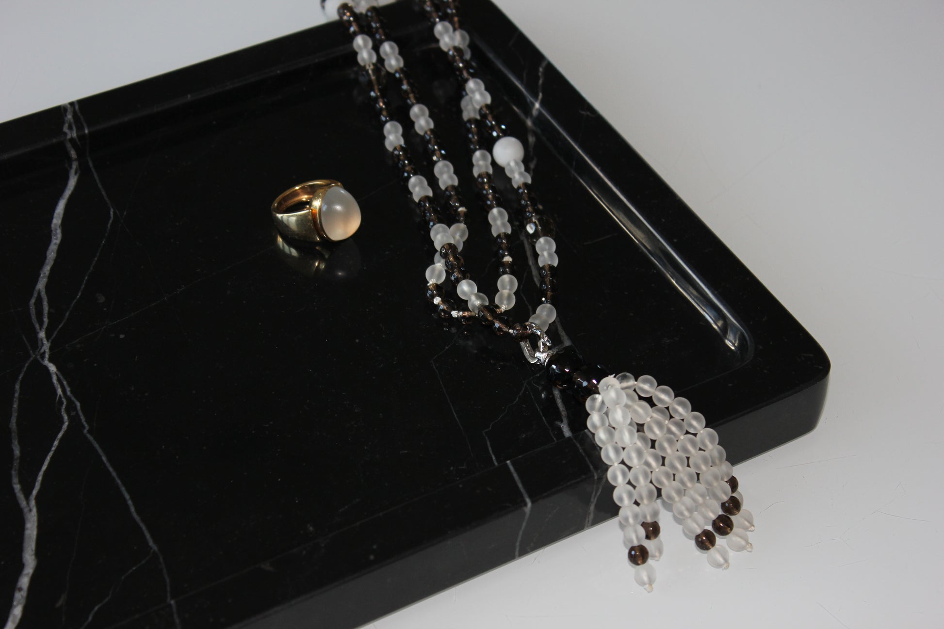 Jewellery displayed on The Monolith tray crafted from Nero Marquina marble.