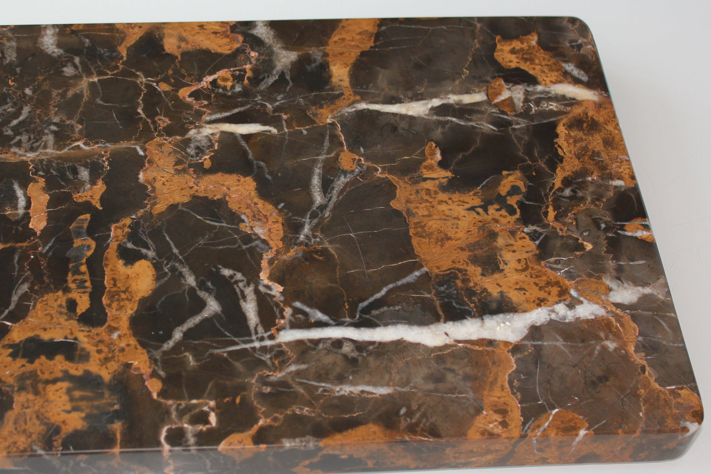 Polished underside of The Monolith Portoro marble tray.