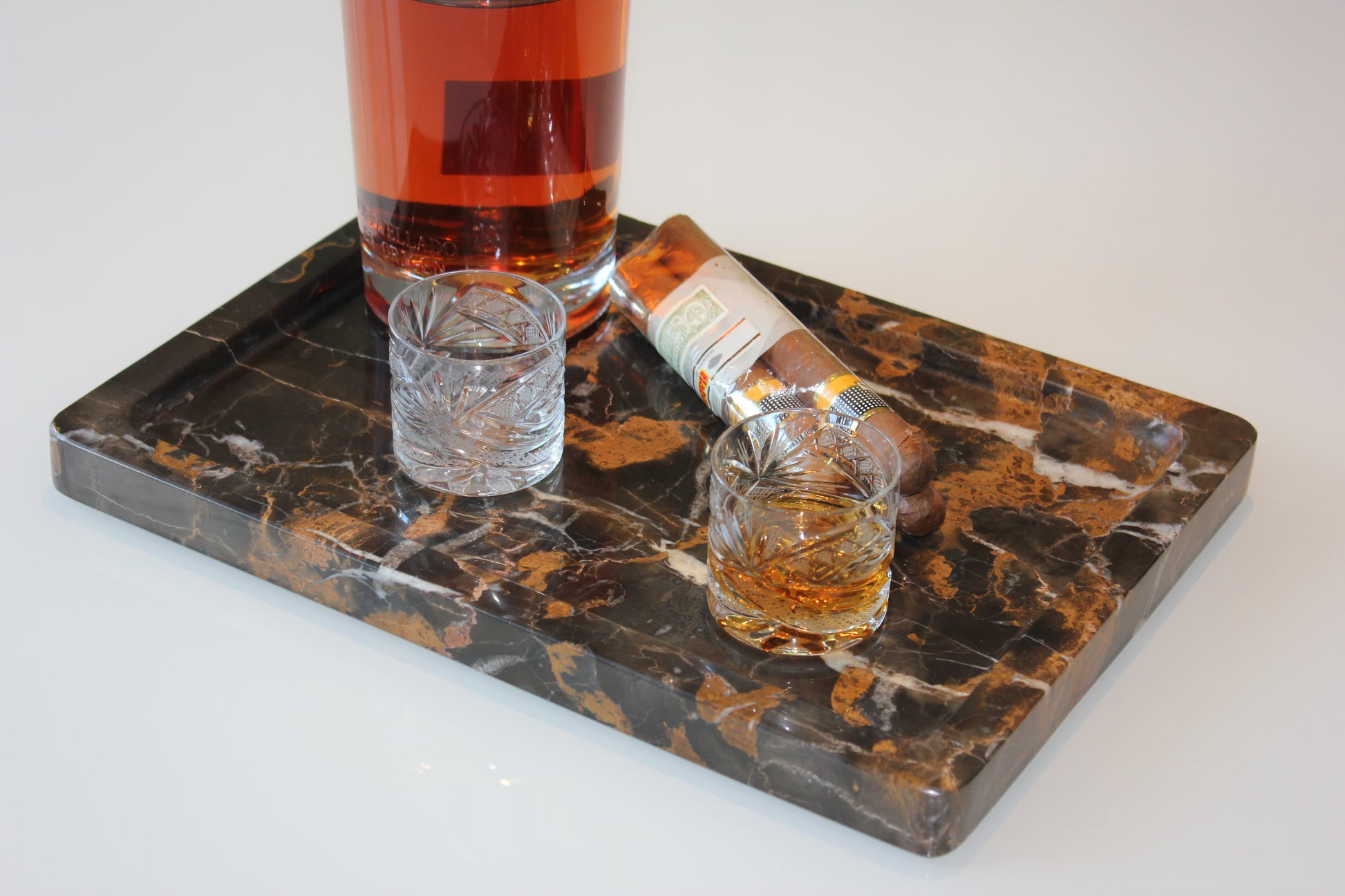 The Monolith tray crafted from natural Portoro marble with distinctive golden veining.