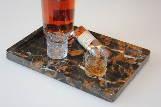 The Monolith tray crafted from natural Portoro marble with distinctive golden veining.