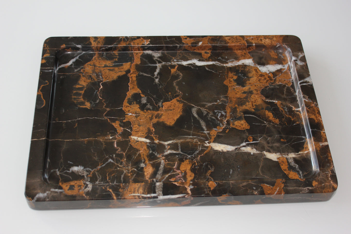 The Monolith tray crafted from natural Portoro marble with distinctive golden veining.