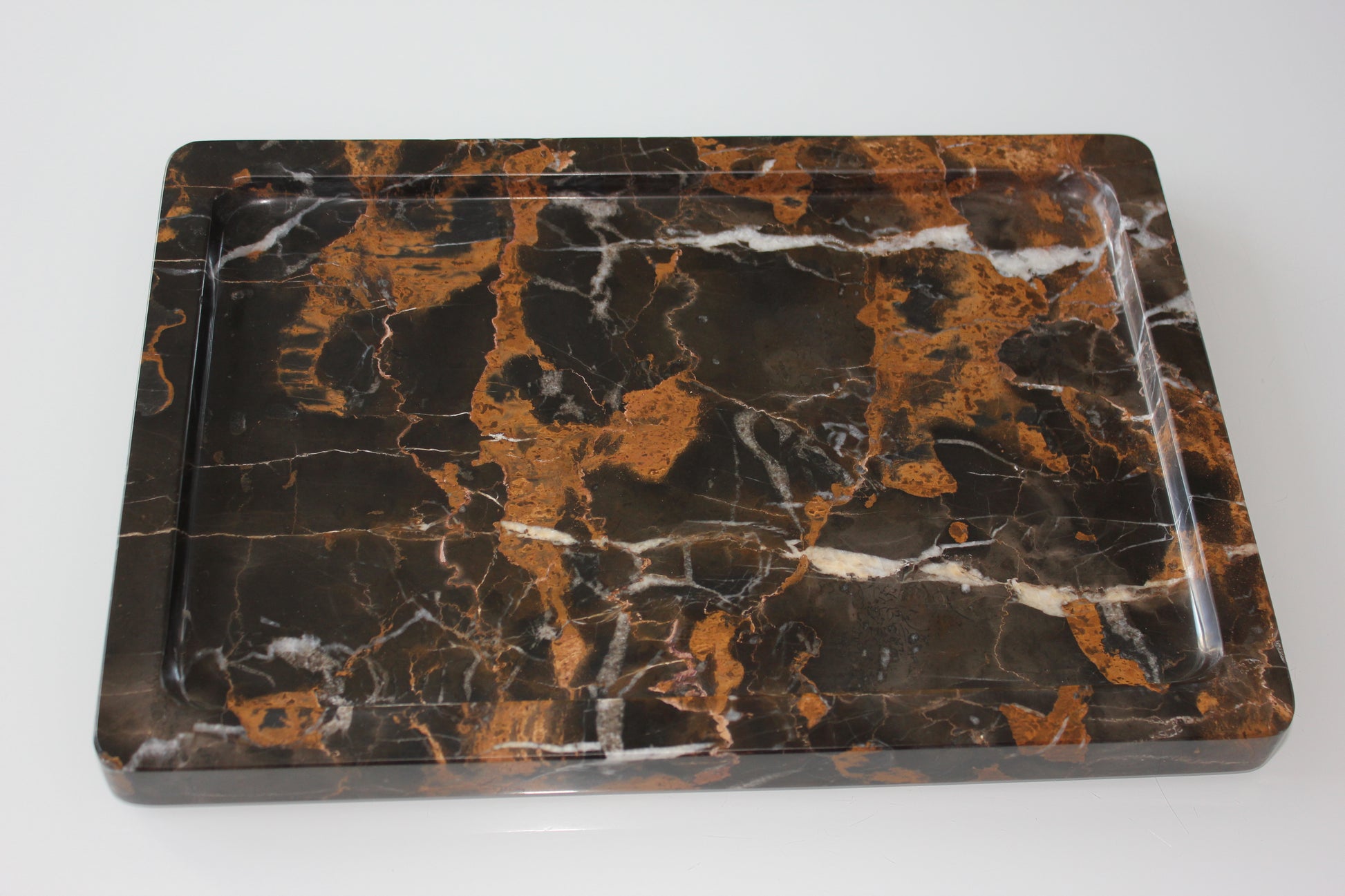 The Monolith tray crafted from natural Portoro marble with distinctive golden veining.